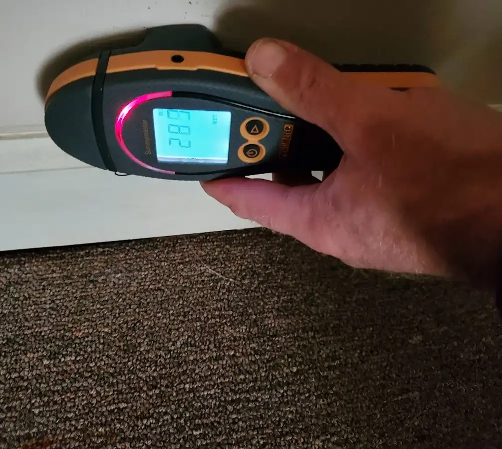 Moisture detection at baseboard during Storm Damage Restoration in Four Square Mile